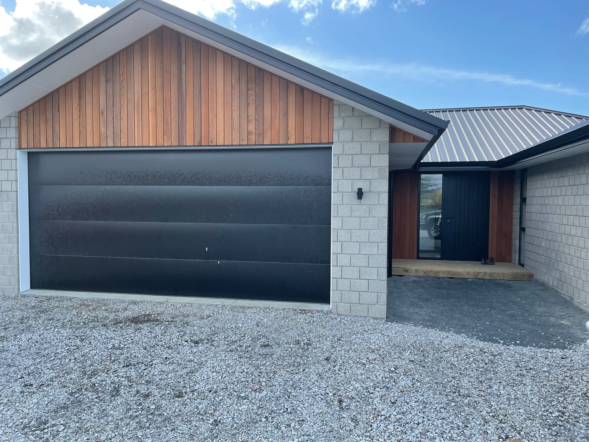 Front elevation with cedar gable and garage