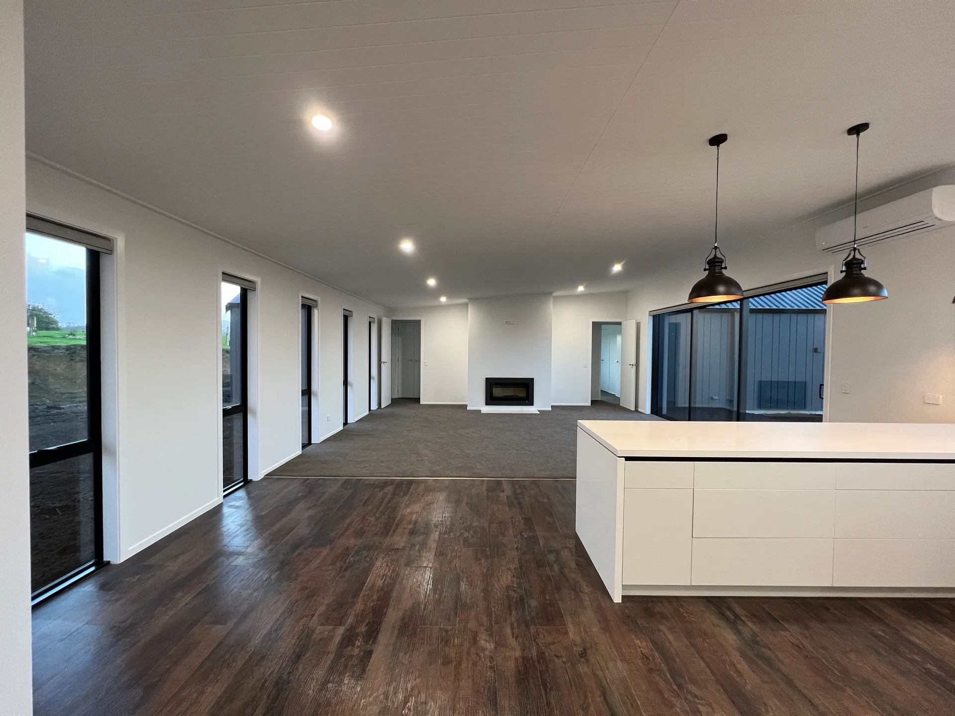 Open-plan living with fireplace and kitchen