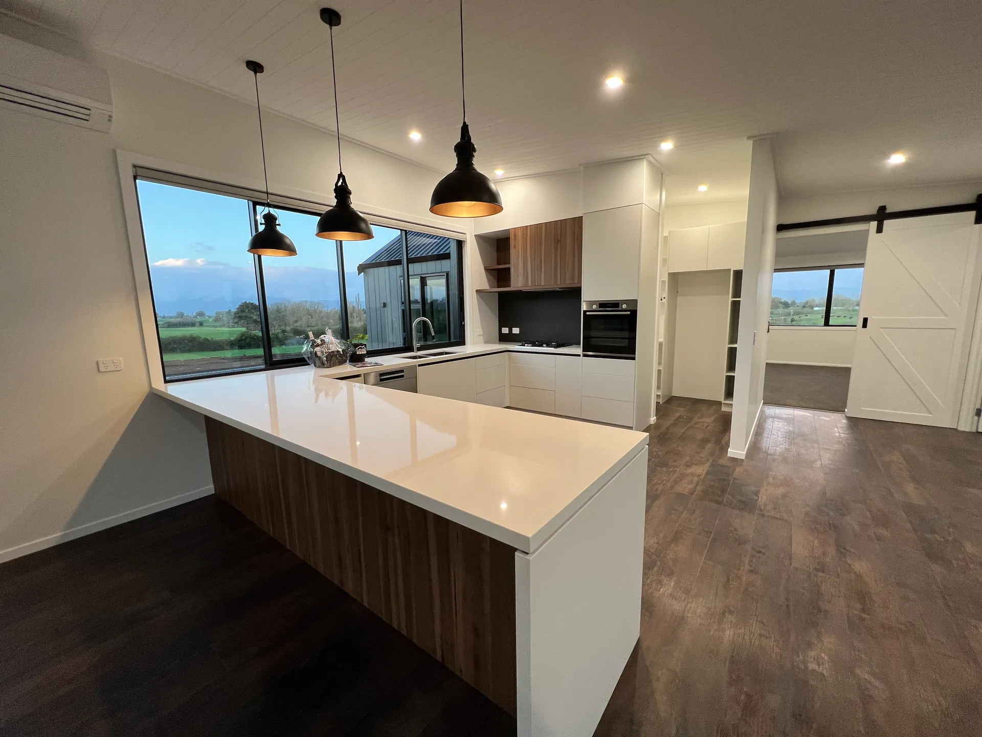 Living space at dusk with rural views