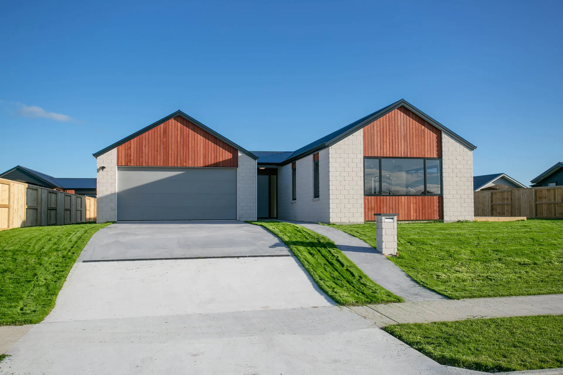 Block and cedar home with double gable street view