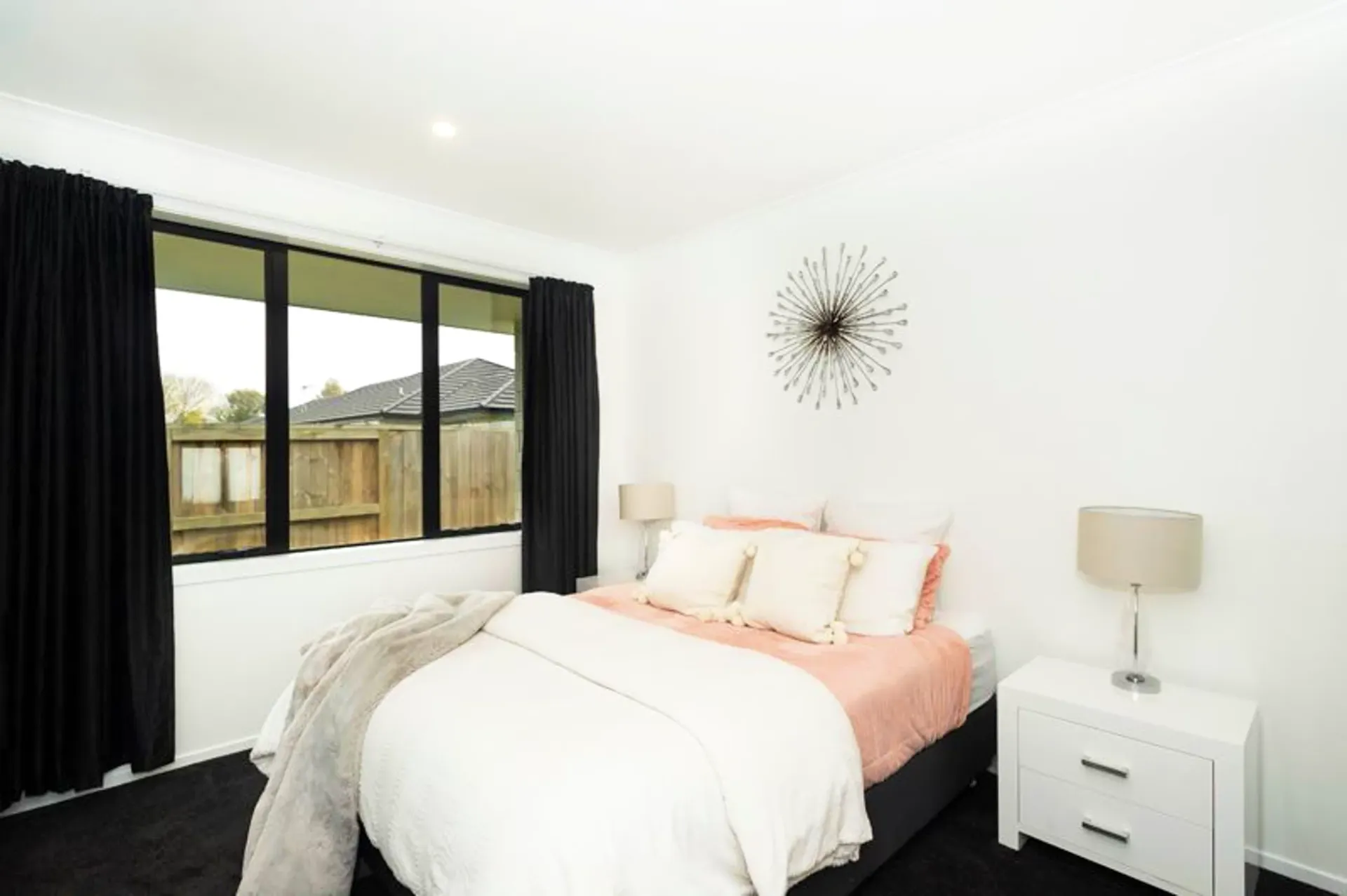 Second bedroom with starburst wall art