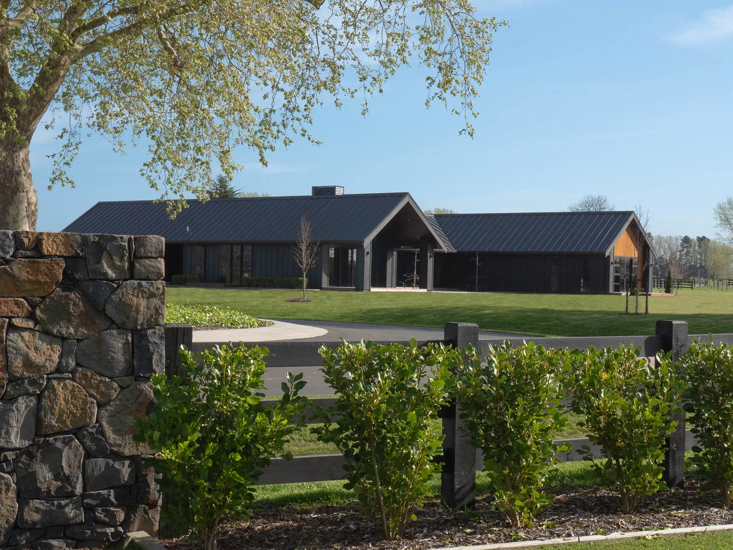 Street view from behind stone wall and hedging