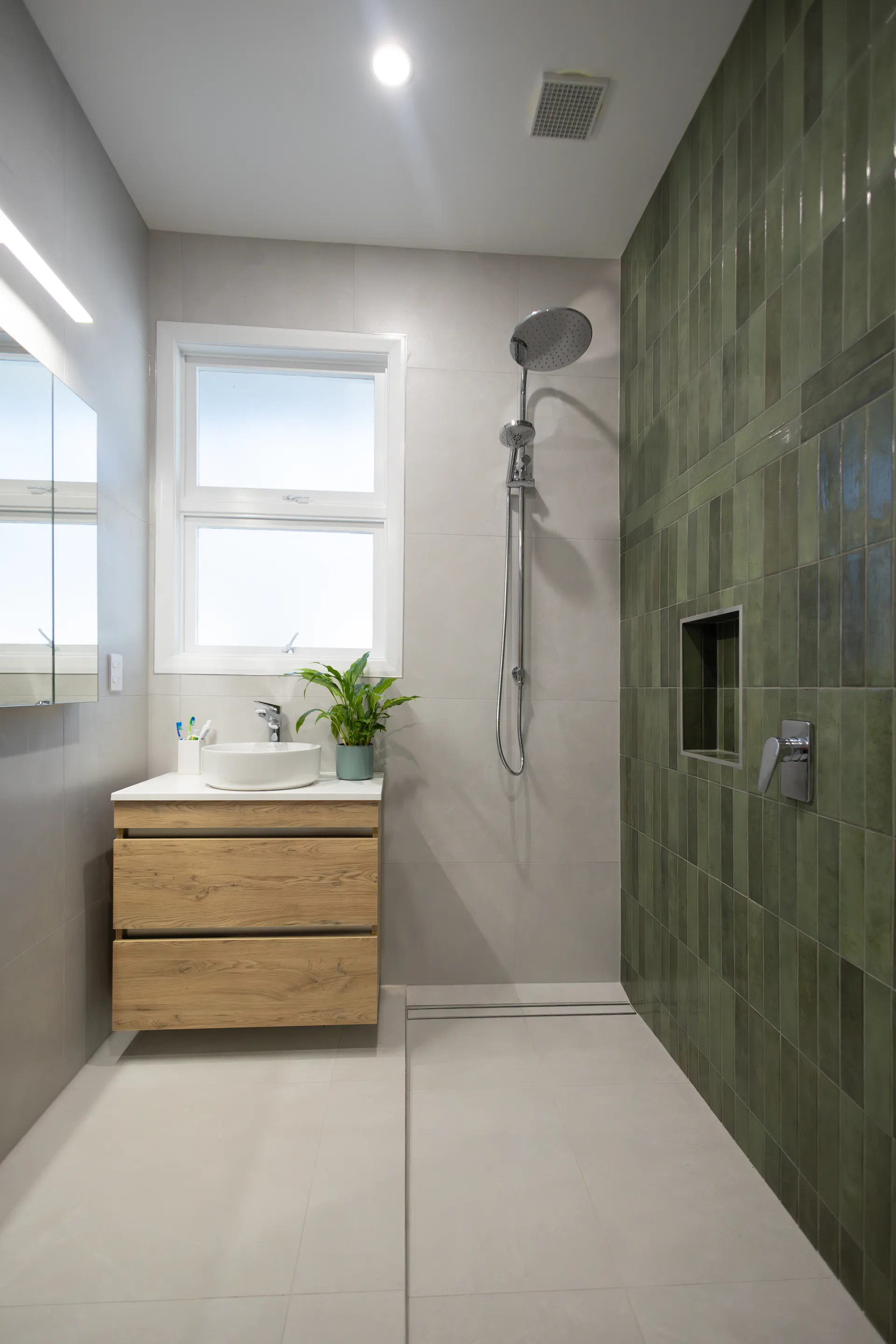 Bathroom with green feature tiles and walk-in shower