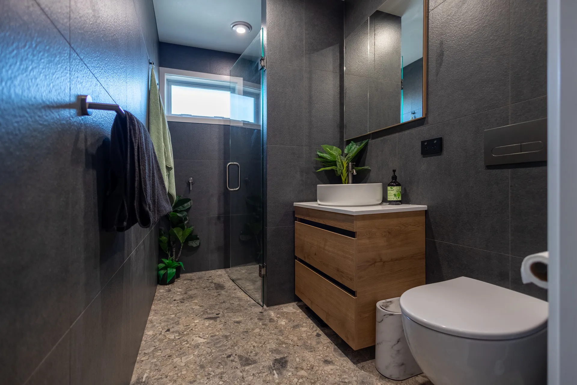Dark bathroom with walk-in shower